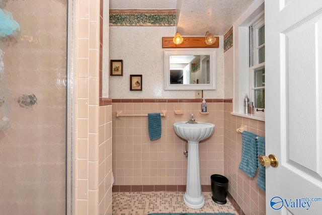 bathroom with tile walls and an enclosed shower