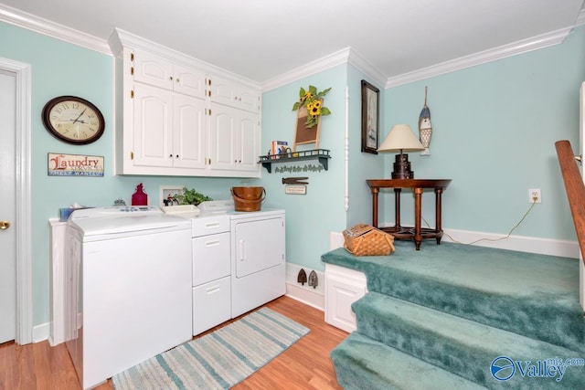 laundry area featuring cabinets, independent washer and dryer, ornamental molding, and light hardwood / wood-style flooring