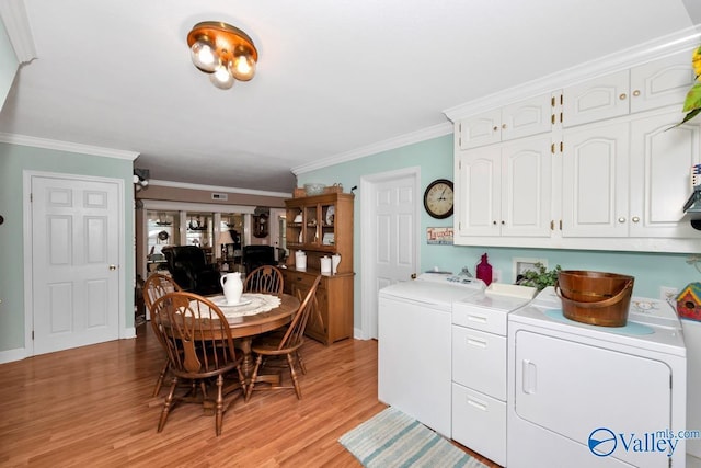 laundry area featuring cabinets, ornamental molding, light hardwood / wood-style floors, and independent washer and dryer