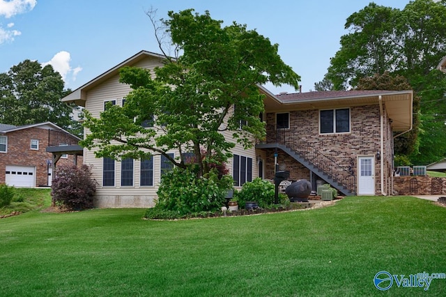 view of front of property with cooling unit, a garage, and a front lawn