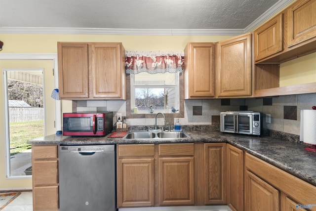 kitchen with decorative backsplash, dark countertops, crown molding, stainless steel dishwasher, and a sink