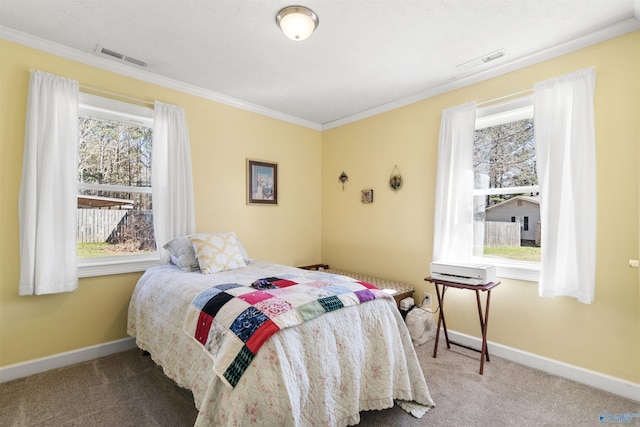 bedroom featuring baseboards, visible vents, carpet flooring, and ornamental molding