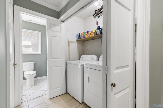 laundry area with laundry area, light tile patterned floors, visible vents, ornamental molding, and washing machine and dryer