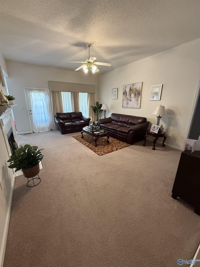 living room featuring ceiling fan, a textured ceiling, and carpet flooring