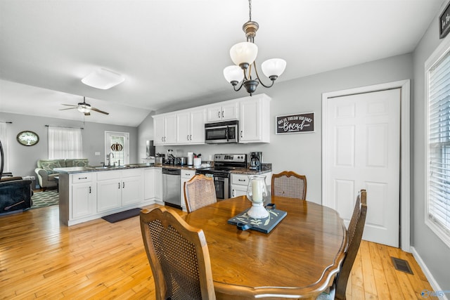 dining space featuring ceiling fan with notable chandelier, light hardwood / wood-style flooring, and plenty of natural light