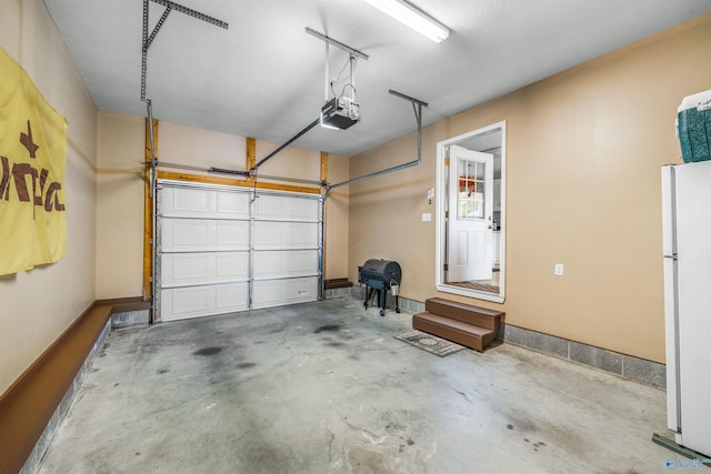 garage with a garage door opener and white refrigerator