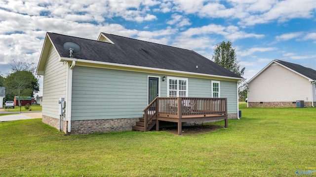 rear view of house featuring a deck and a yard