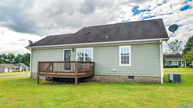 back of house with cooling unit, a deck, and a yard