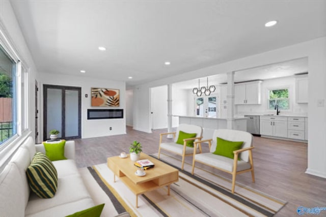 living room with light hardwood / wood-style floors and sink