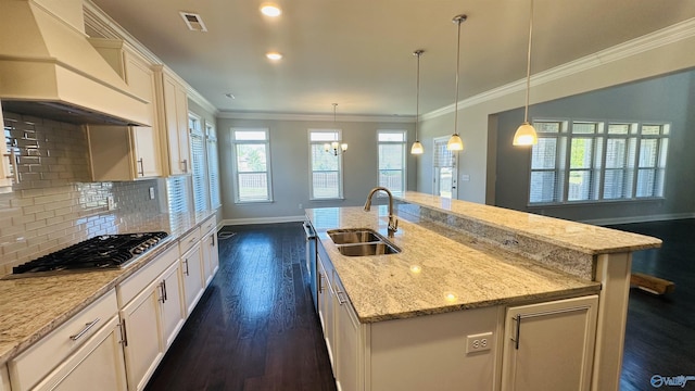 kitchen with premium range hood, stainless steel gas stovetop, a sink, baseboards, and dark wood-style flooring