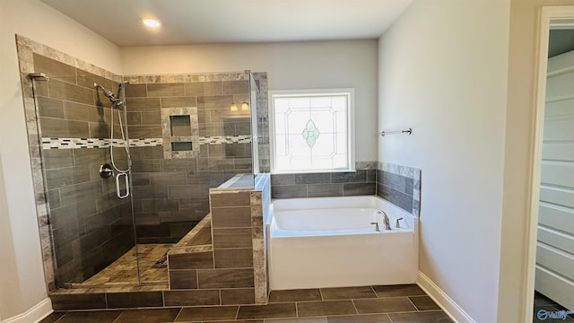 full bath featuring a stall shower, a garden tub, baseboards, tile patterned floors, and recessed lighting