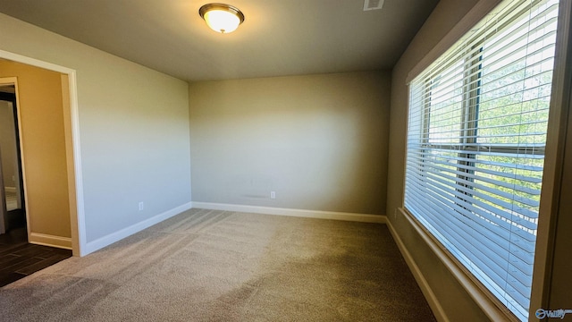 empty room with carpet flooring and baseboards