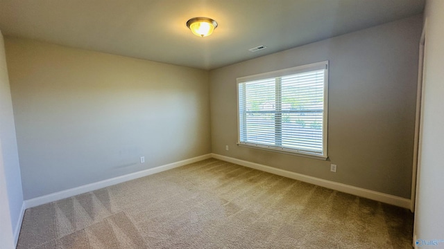 carpeted spare room with baseboards