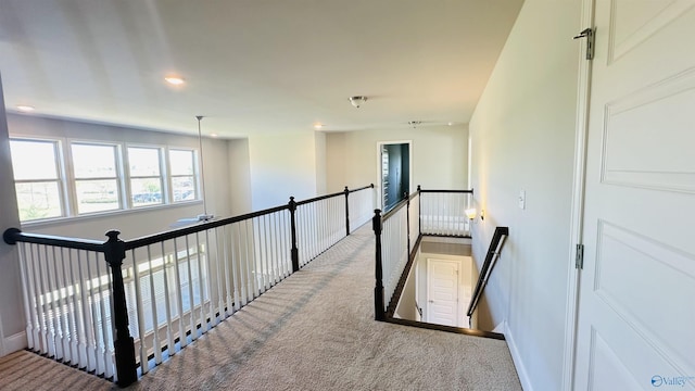 corridor with an upstairs landing, carpet flooring, baseboards, and recessed lighting