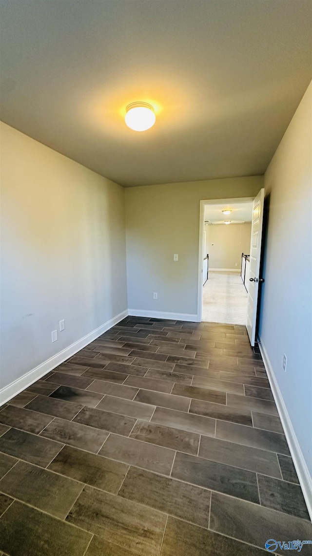 spare room featuring baseboards
