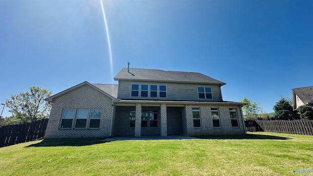 rear view of property with brick siding and a patio