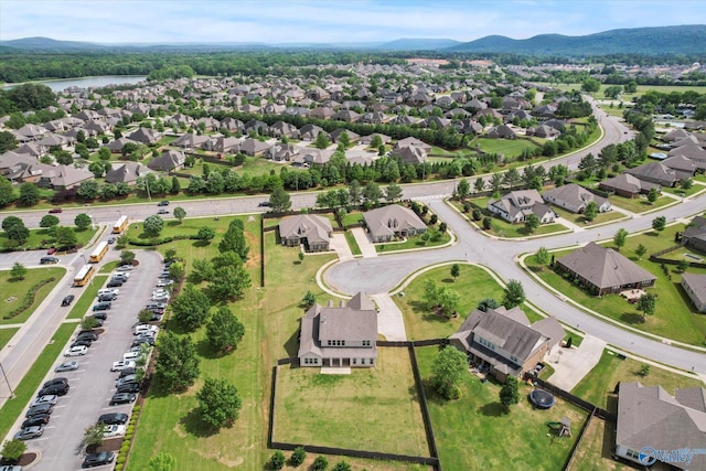 aerial view of property and surrounding area with nearby suburban area and a water and mountain view