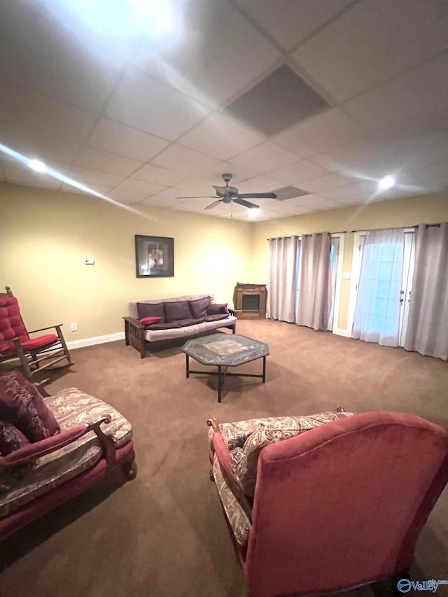 carpeted living room featuring a paneled ceiling and ceiling fan