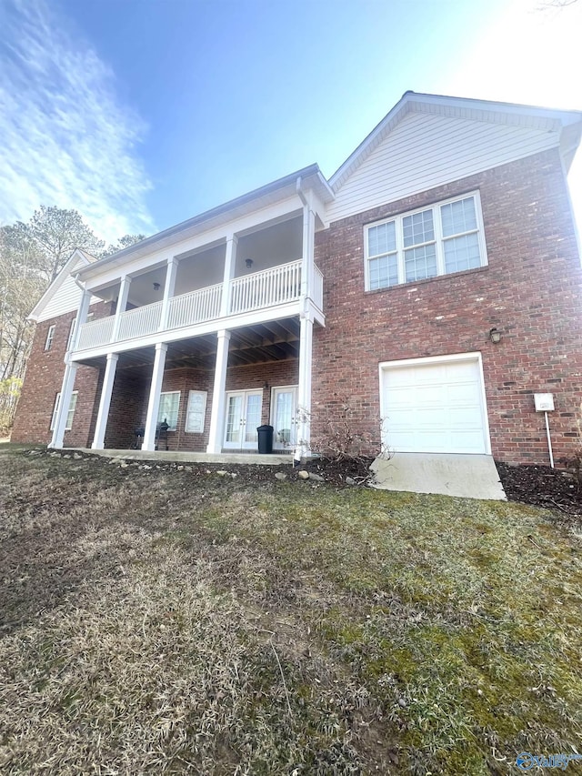 back of house featuring a garage and a balcony