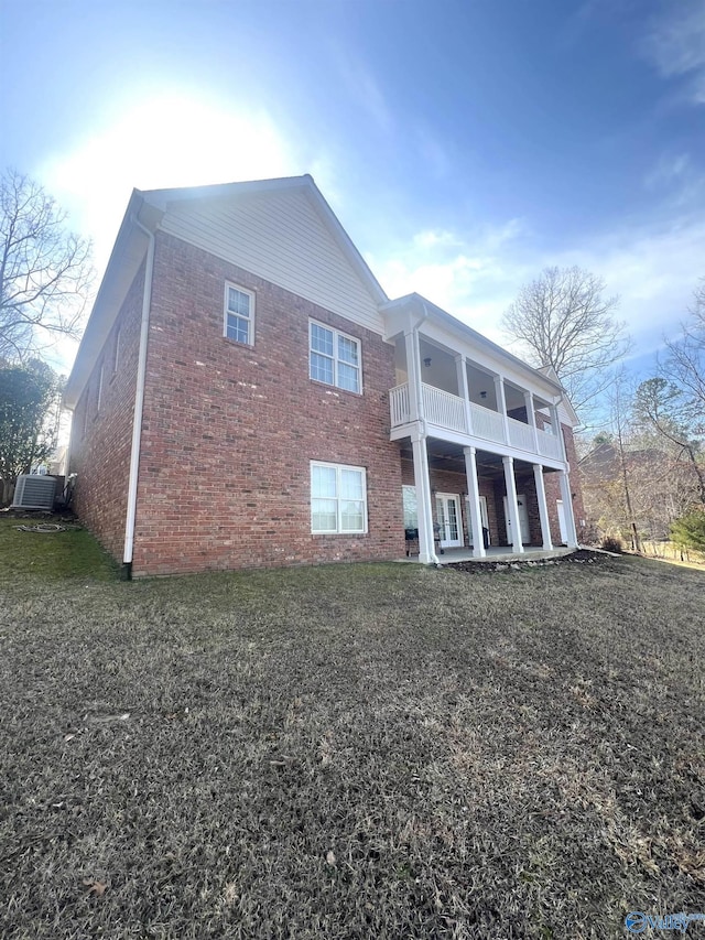 back of property with a balcony and central air condition unit