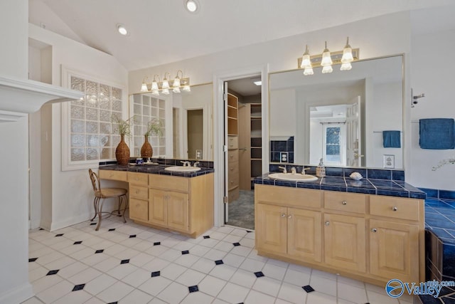 bathroom featuring vanity, tile patterned floors, and lofted ceiling