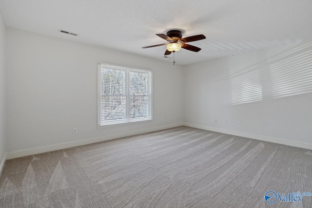 unfurnished room featuring light colored carpet and ceiling fan