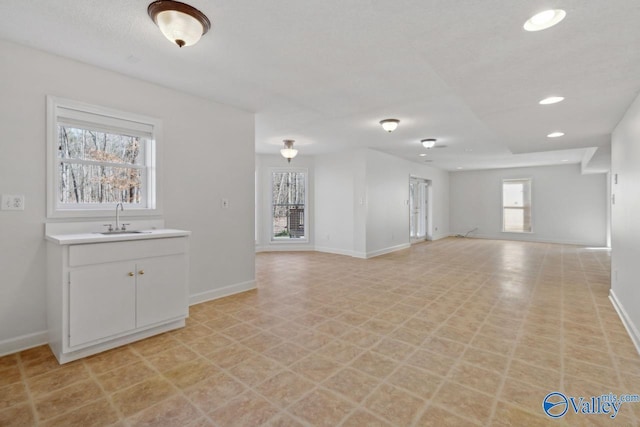 unfurnished living room featuring sink