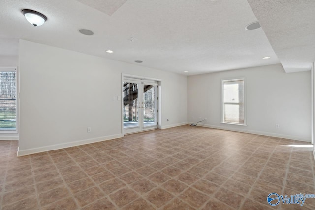 empty room featuring a textured ceiling