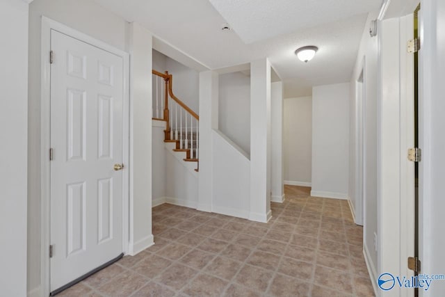 hallway featuring a textured ceiling