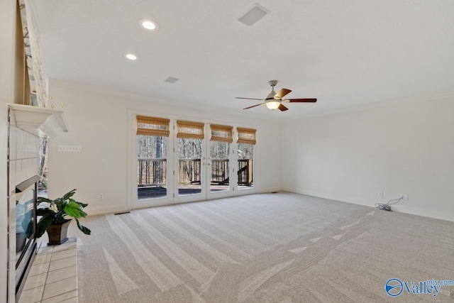 unfurnished living room with ceiling fan, ornamental molding, and a fireplace