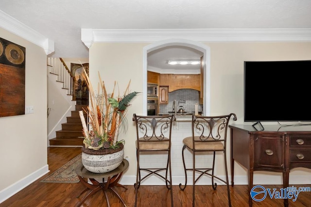 interior space featuring hardwood / wood-style flooring and ornamental molding