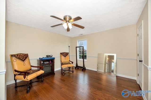 sitting room featuring dark hardwood / wood-style floors and ceiling fan