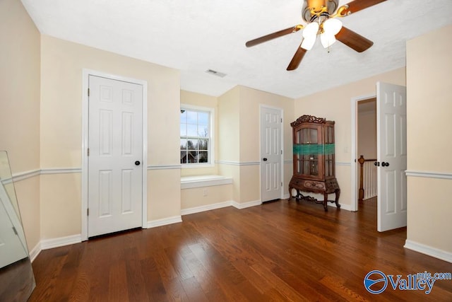 interior space with dark hardwood / wood-style floors and ceiling fan