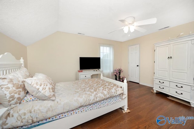 bedroom with vaulted ceiling, dark hardwood / wood-style floors, and ceiling fan