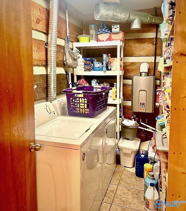 laundry room featuring washer and clothes dryer and light tile patterned floors