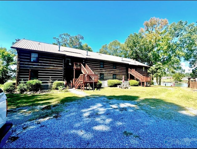 rear view of property featuring a yard