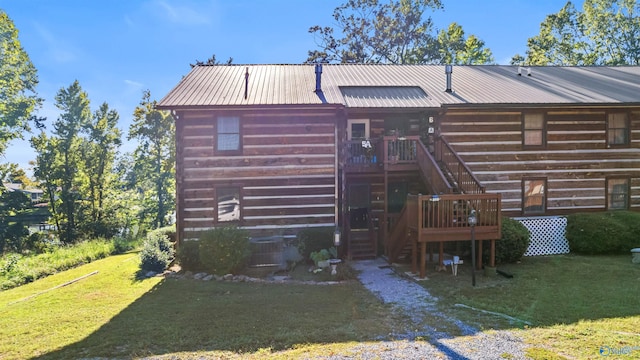 back of house with a lawn and a deck