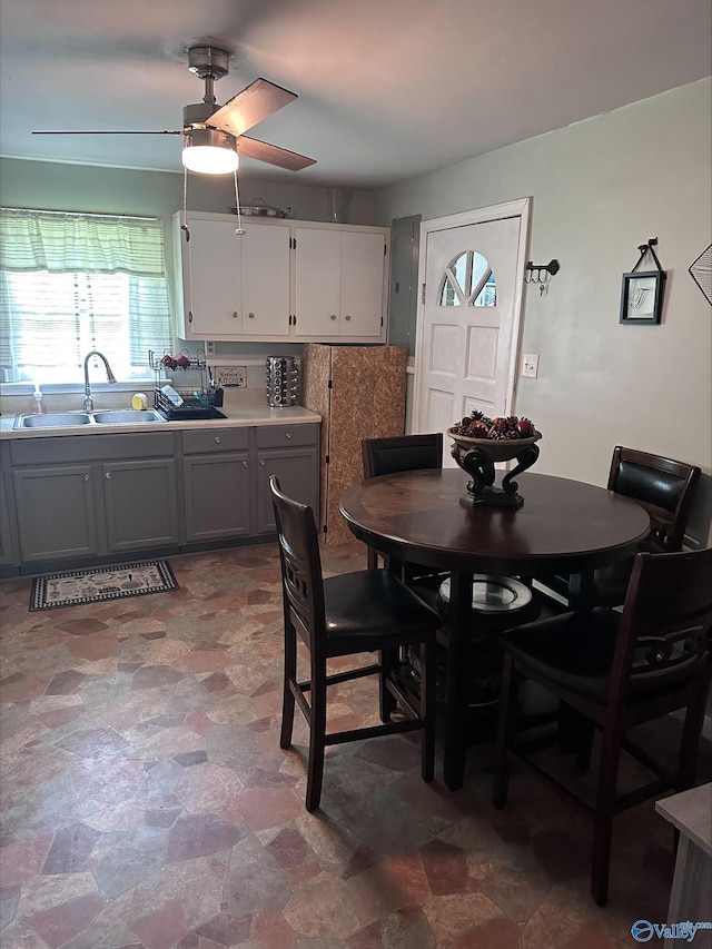 dining room with a ceiling fan and stone finish flooring