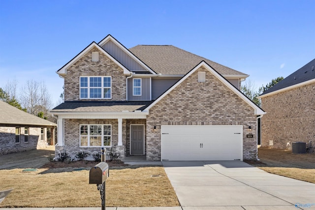 craftsman-style home featuring an attached garage, central AC, a shingled roof, concrete driveway, and board and batten siding