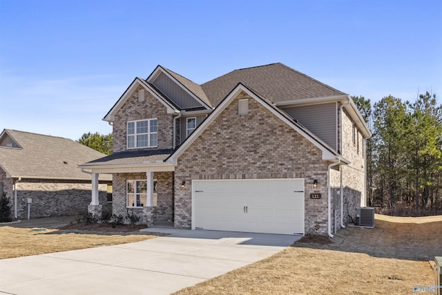 craftsman house featuring a garage, concrete driveway, brick siding, and central AC unit