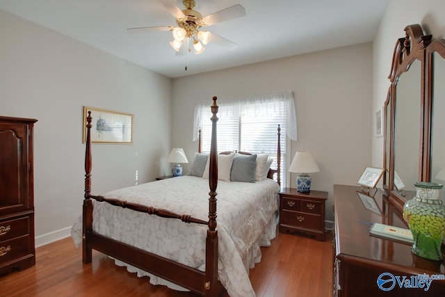 bedroom with baseboards, a ceiling fan, and light wood finished floors