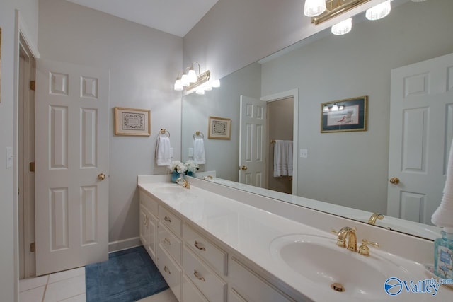 bathroom with a sink, double vanity, and tile patterned flooring