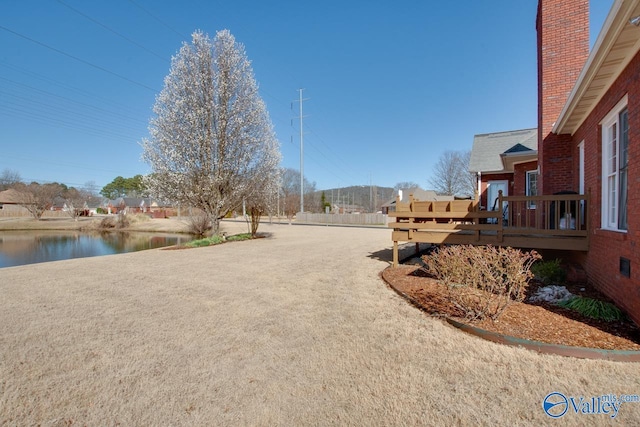 view of road featuring driveway and a water view