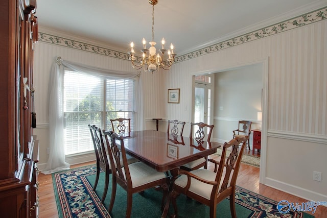 dining room featuring wallpapered walls, crown molding, and light wood-type flooring