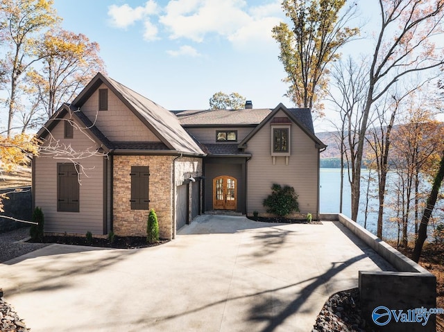 view of front facade featuring a water view and french doors