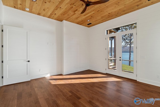 empty room with hardwood / wood-style flooring, ceiling fan, and wooden ceiling