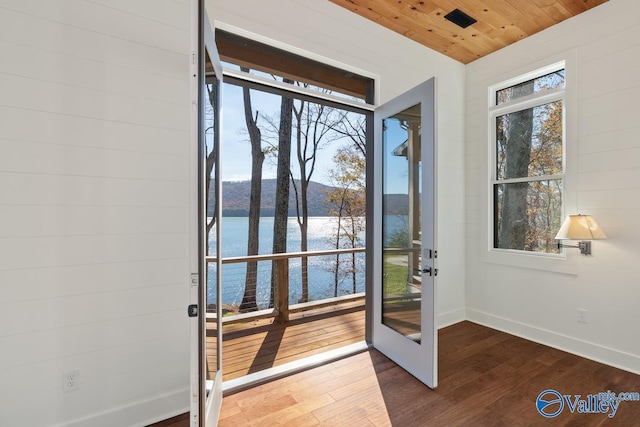 entryway featuring hardwood / wood-style floors, a water view, and wooden ceiling