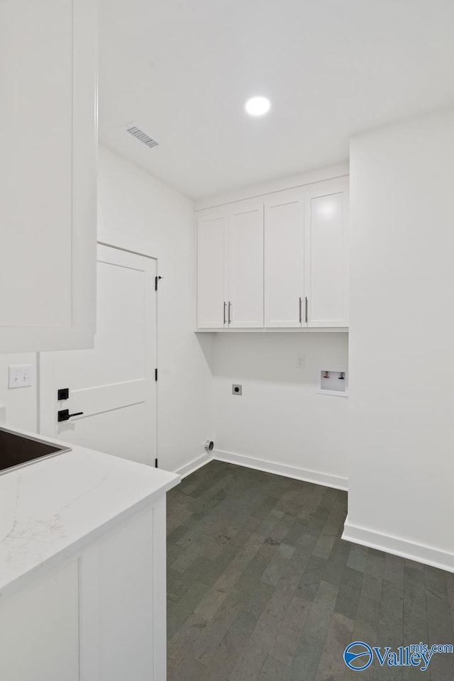 laundry room with electric dryer hookup, cabinets, sink, hookup for a washing machine, and dark hardwood / wood-style floors