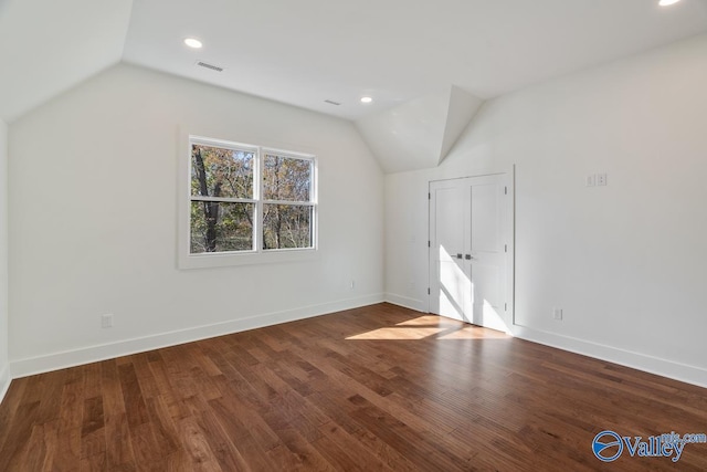 bonus room with wood-type flooring and lofted ceiling