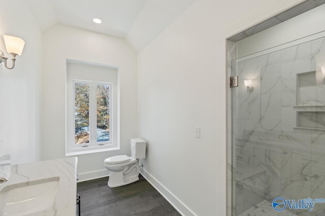 bathroom featuring an enclosed shower, vanity, hardwood / wood-style flooring, toilet, and lofted ceiling